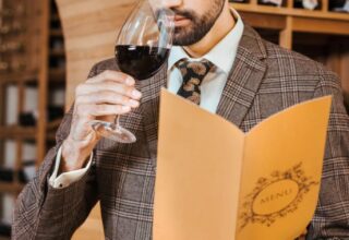 Professional wine taster swirling a glass of red wine