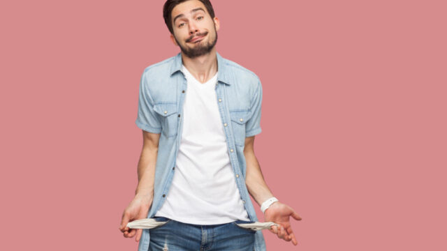 Man showing empty pockets illustrating scarcity language and the feeling of having no money.