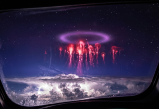 Red sprites and elve ring plasma discharge above thunderstorm captured from aircraft window — Earth's atmospheric electrical circuit visible